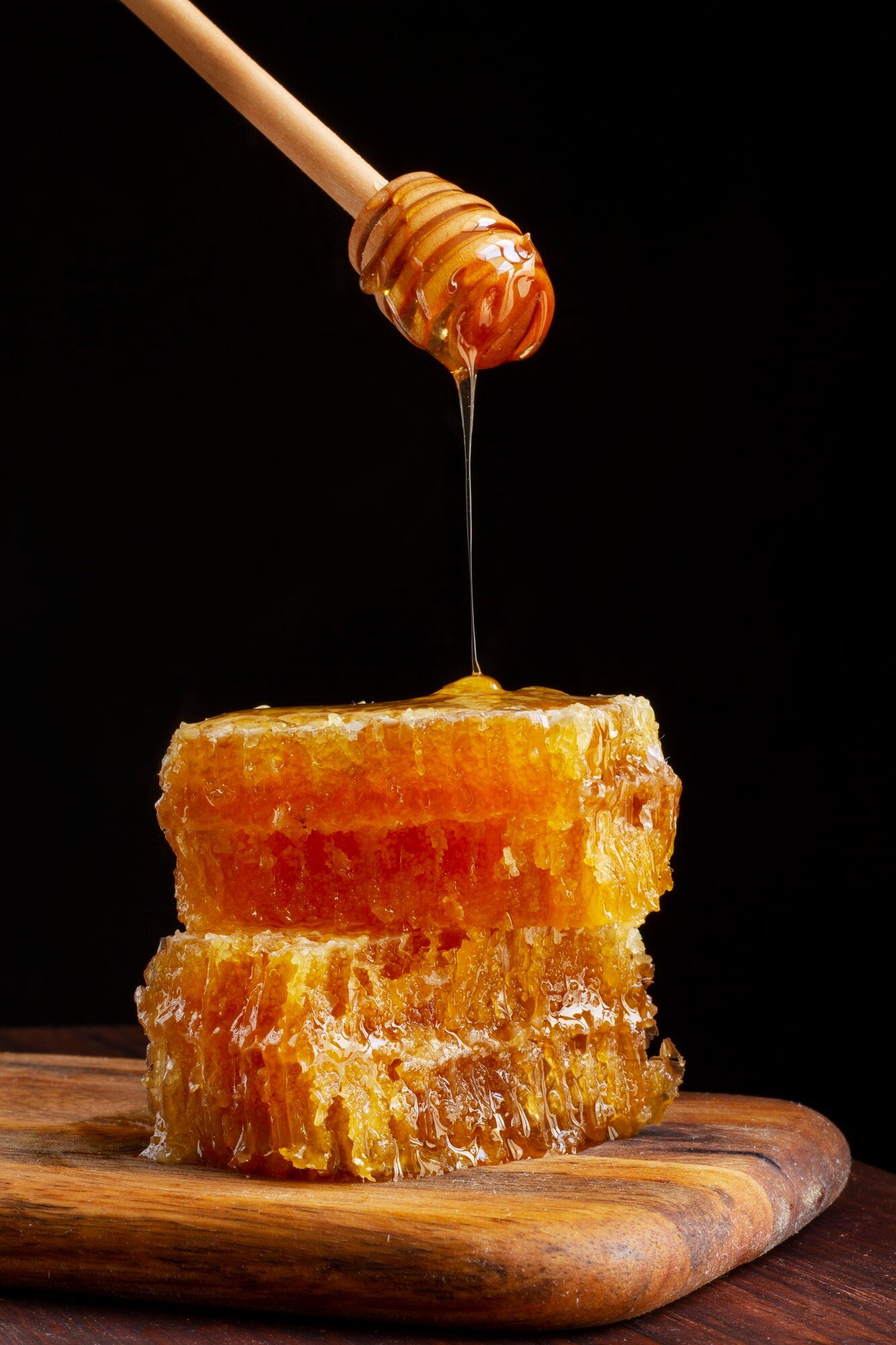 front-view-honey-dipper-dripping-honey-honeycomb_23-2149442386